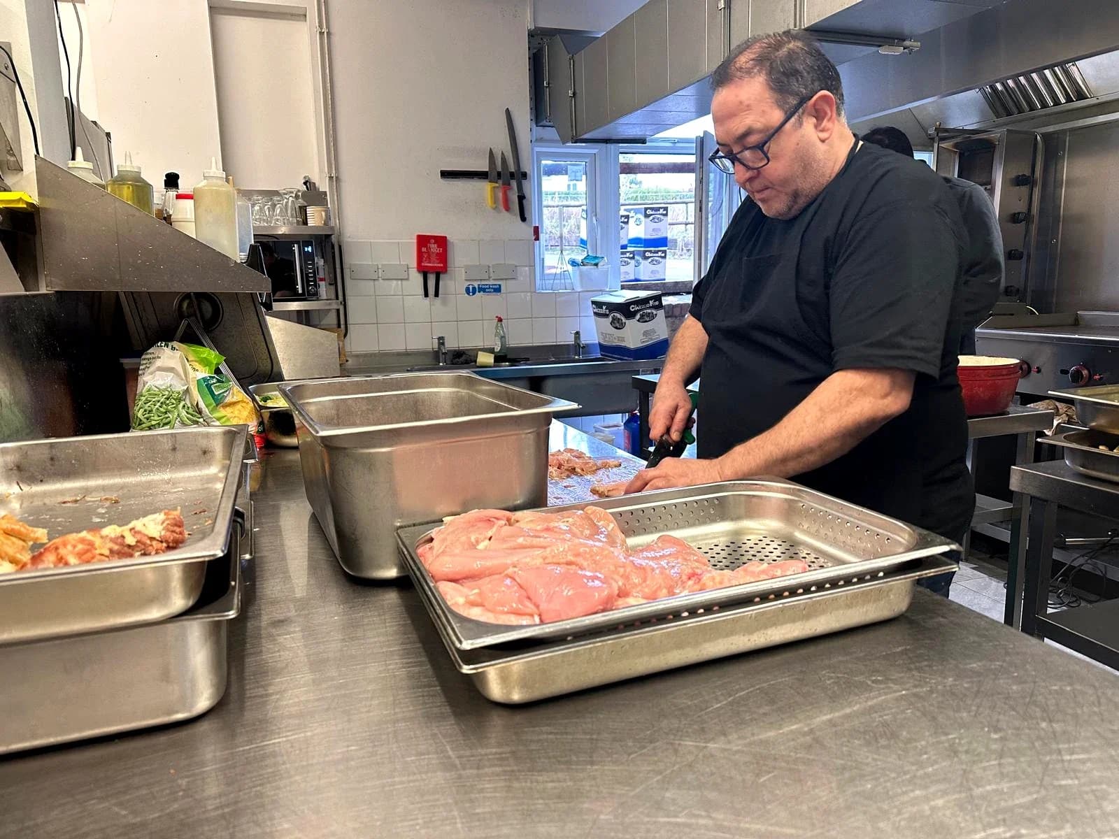 Chef Ahmet preparing food in a professional kitchen